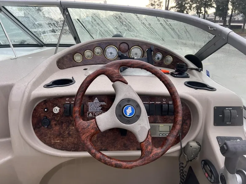 Slide: The Image of 2004 Four Winns 248 Vista boat dashboard with wood-grain steering wheel and instrument panel. - 7
