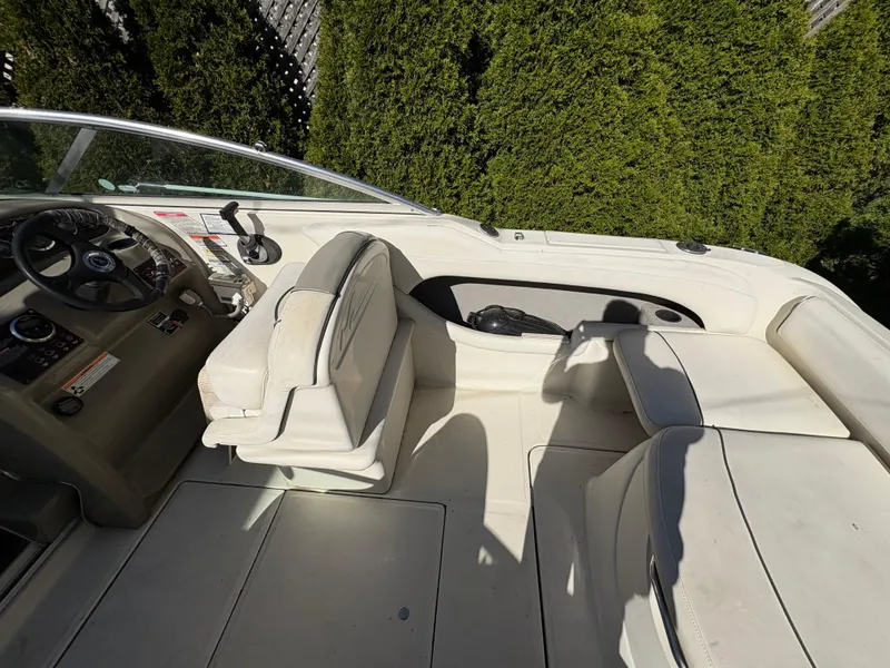 Slide: The Image of 2007 Sea Ray 215 Weekender boat interior with seating and steering wheel. - 12