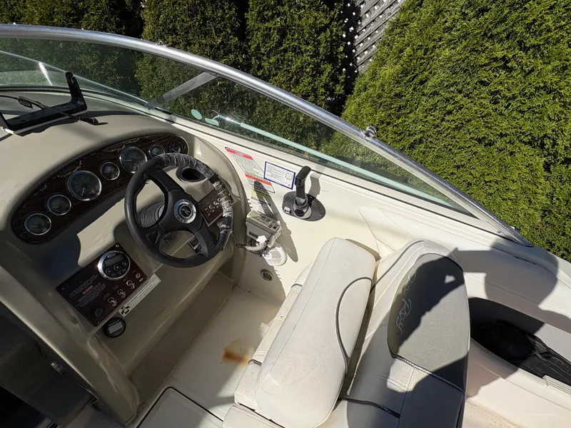 Slide: The Image of 2007 Sea Ray 215 Weekender boat cockpit with steering wheel and control panel. - 13