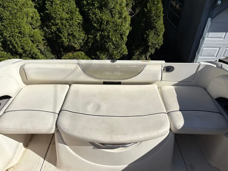 Slide: The Image of 2007 Sea Ray 215 Weekender boat seating area with white upholstery. - 15
