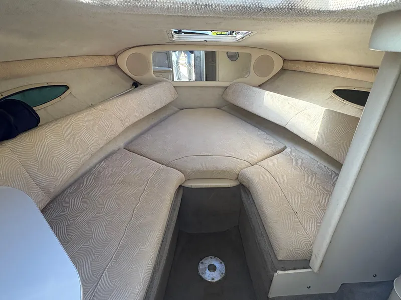 Slide: The Image of 2007 Sea Ray 215 Weekender cabin interior with beige upholstery and compact design. - 16