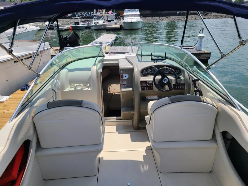 Slide: The Image of 2007 Sea Ray 215 Weekender boat interior with steering wheel and seating at dock. - 19