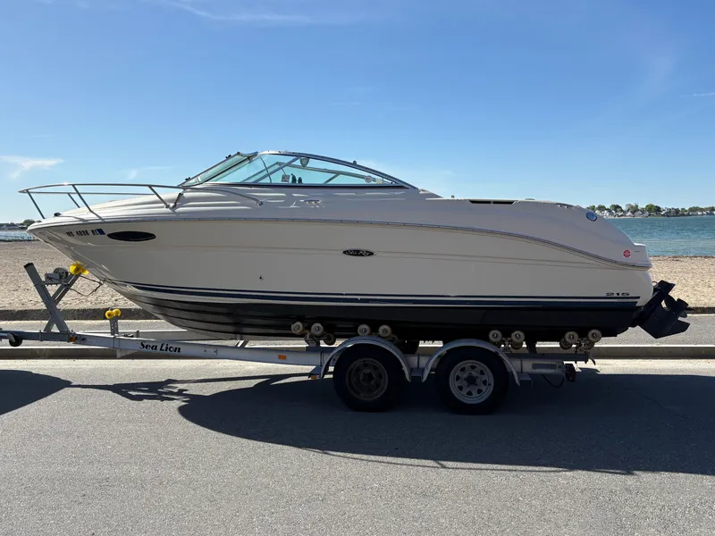 Slide: The Image of 2007 Sea Ray 215 Weekender boat on trailer by the beach. - 6