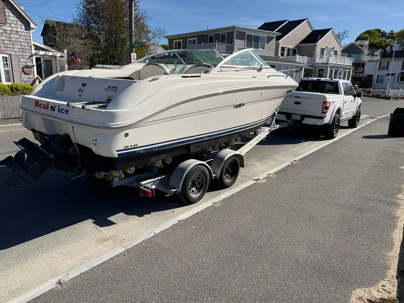Slide: The Image of 2007 Sea Ray 215 Weekender boat on trailer, parked on street near houses. - 8