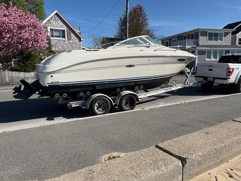 Slide: The Image of 2007 Sea Ray 215 Weekender boat on trailer, parked on a residential street. - 9
