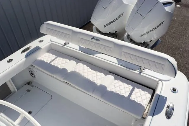 Slide: The Image of 2025 Yellowfin 26 Hybrid boat with white seating and dual Mercury engines. - 11