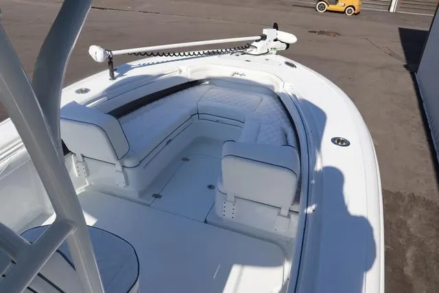 Slide: The Image of 2025 Yellowfin 26 Hybrid boat with white seating and trolling motor on deck. - 15
