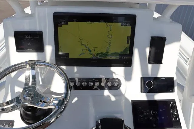 Slide: The Image of Helm of 2025 Yellowfin 26 Hybrid boat with navigation display and controls. - 16