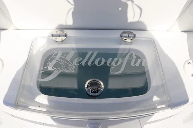 Slide: The Image of 2025 Yellowfin 26 Hybrid livewell with clear lid and logo. - 26