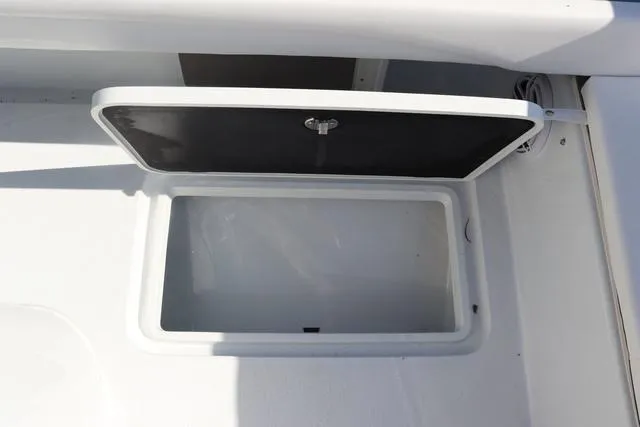 Slide: The Image of Open storage compartment on 2025 Yellowfin 26 Hybrid boat. - 28