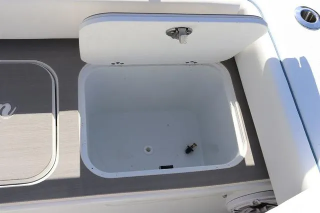 Slide: The Image of Open storage compartment on 2025 Yellowfin 26 Hybrid boat deck. - 32