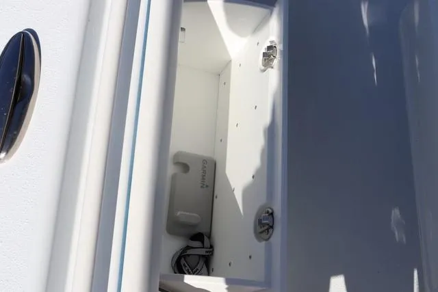 Slide: The Image of 2025 Yellowfin 26 Hybrid boat storage compartment with Garmin equipment. - 34