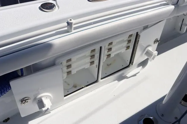 Slide: The Image of 2025 Yellowfin 26 Hybrid boat storage compartments with open doors, showcasing interior design. - 35