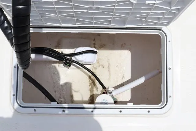 Slide: The Image of Open storage compartment in 2023 May-Craft 1900 CC boat, showing interior and wiring. - 17