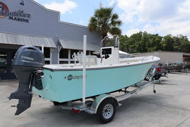 Slide: The Image of 2023 May-Craft 1900 CC boat on trailer, parked outside dealership, featuring Yamaha outboard motor. - 2