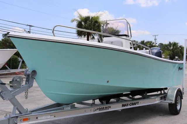 Slide: The Image of 2023 May-Craft 1900 CC boat on trailer, light blue hull, parked outdoors. - 6