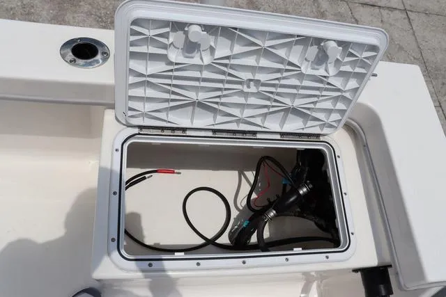 Slide: The Image of Open storage compartment on 2023 May-Craft 1900 CC boat, showing wiring and components. - 14