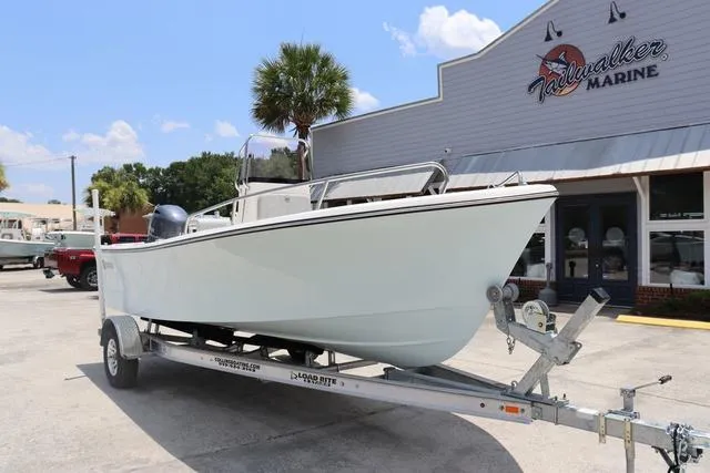 Slide: The Image of 2023 May-Craft 1900 CC boat on trailer outside dealership, clear sky background. - 2