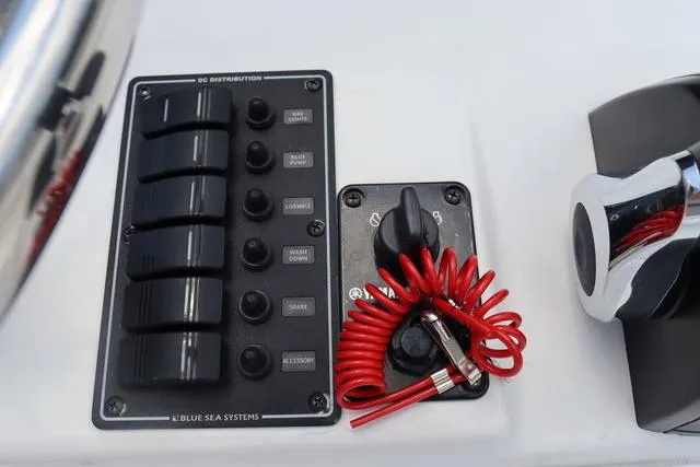 Slide: The Image of Control panel of 2023 May-Craft 1900 CC boat with switches and safety lanyard. - 23
