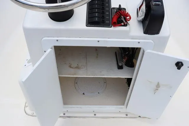 Slide: The Image of Open storage compartment on 2023 May-Craft 1900 CC boat console. - 24
