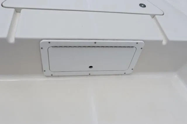 Slide: The Image of 2023 May-Craft 1900 CC boat interior detail, featuring a white storage compartment. - 25