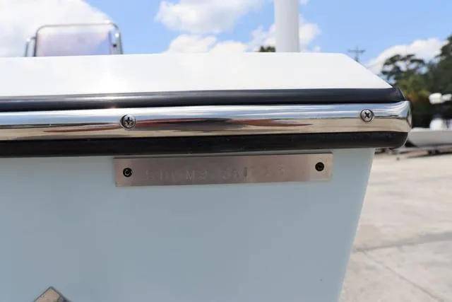 Slide: The Image of 2023 May-Craft 1900 CC boat detail with metal trim and screws under a blue sky. - 33