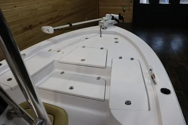 Slide: The Image of 2021 Sportsman Masters 207 Bay Boat interior with storage compartments and trolling motor. - 11
