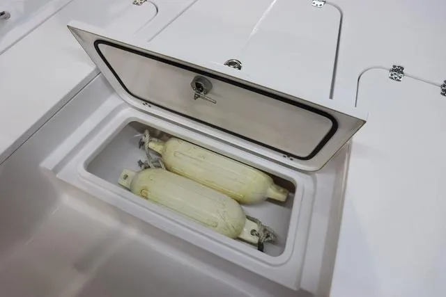 Slide: The Image of Storage compartment on 2021 Sportsman Masters 207 Bay Boat with boat fenders inside. - 14