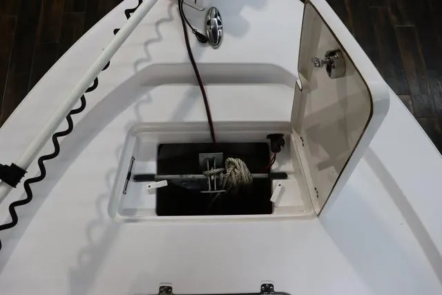 Slide: The Image of 2021 Sportsman Masters 207 Bay Boat anchor storage compartment with open hatch. - 15