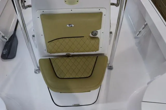 Slide: The Image of 2021 Sportsman Masters 207 Bay Boat seat with tan cushion and storage compartment. - 16