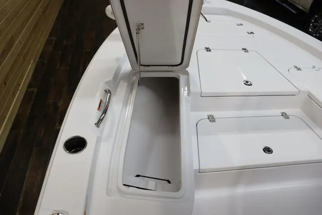 Slide: The Image of 2021 Sportsman Masters 207 Bay Boat with open storage compartment on deck. - 17