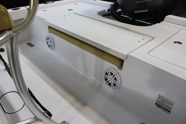 Slide: The Image of 2021 Sportsman Masters 207 Bay Boat interior with speakers and seating area. - 18