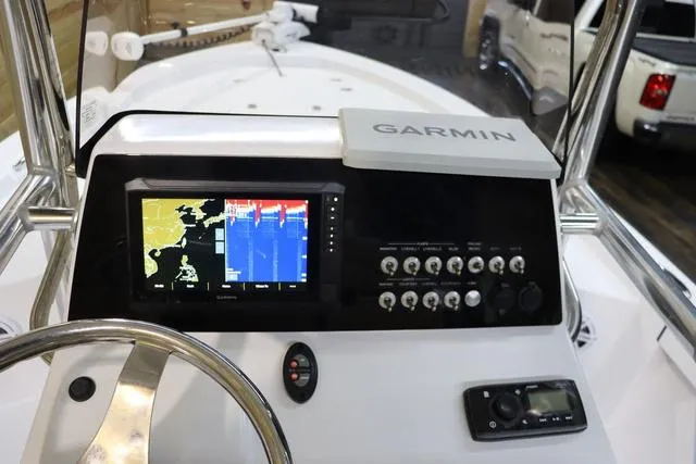 Slide: The Image of 2021 Sportsman Masters 207 Bay Boat dashboard with Garmin navigation system and controls. - 19