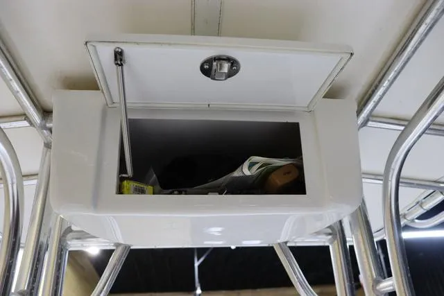 Slide: The Image of Open storage compartment on 2021 Sportsman Masters 207 Bay Boat, showing interior contents. - 21