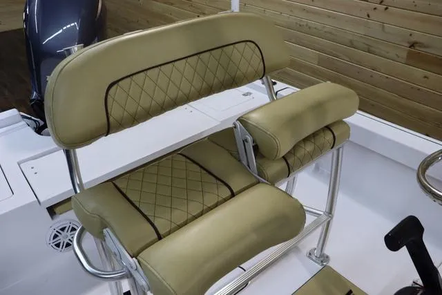 Slide: The Image of 2021 Sportsman Masters 207 Bay Boat with tan cushioned seating and stainless steel frame. - 8