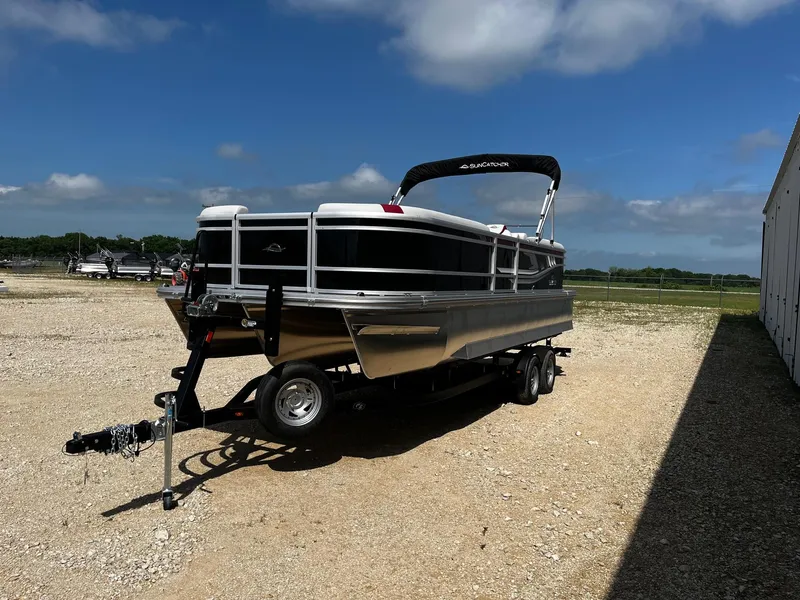 Slide: The Image of 2025 SunCatcher Select 324RC pontoon boat on trailer under clear blue sky. - 3