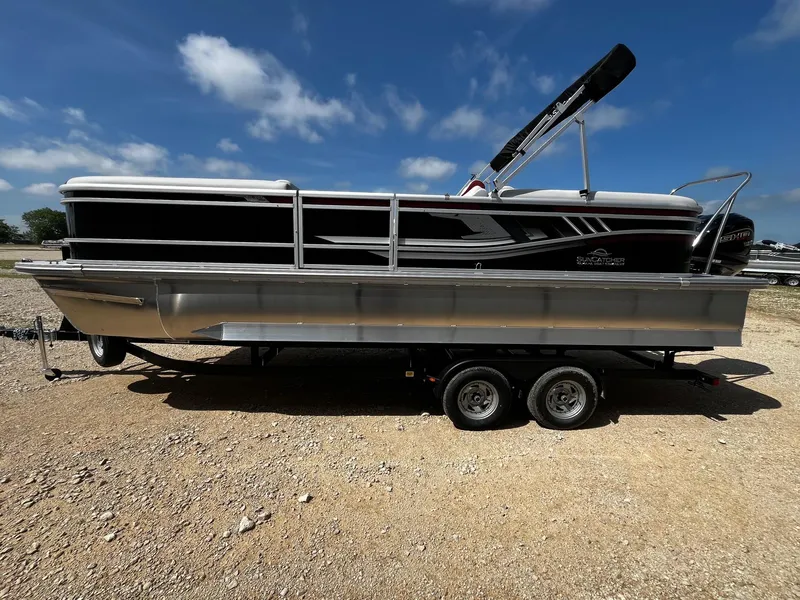 Slide: The Image of 2025 SunCatcher Select 324RC pontoon boat on trailer under blue sky. - 4