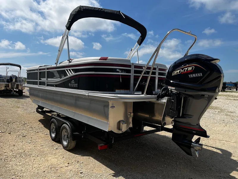 Slide: The Image of 2025 SunCatcher Select 324RC pontoon boat with Yamaha engine on a trailer. - 5