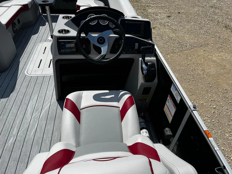 Slide: The Image of 2025 SunCatcher Select 324RC boat interior with steering wheel and control panel. - 9
