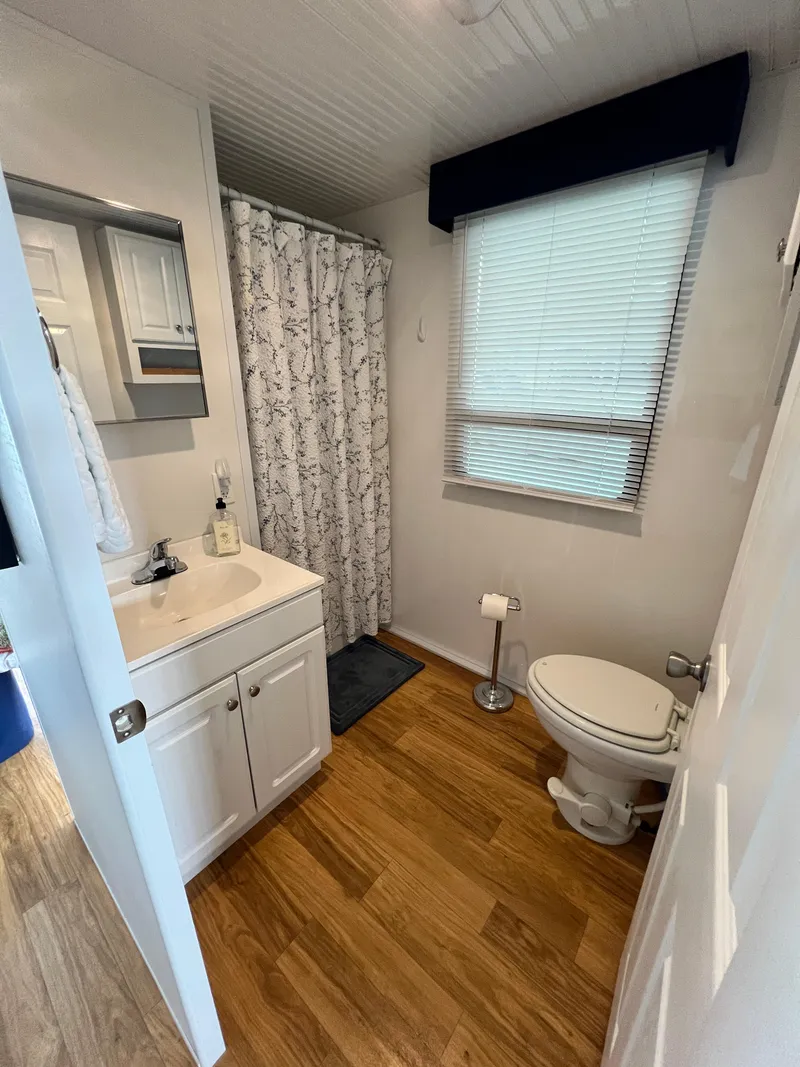 Slide: The Image of Modern bathroom in 2021 Catamaran Cruisers houseboat with shower, sink, and toilet. - 11