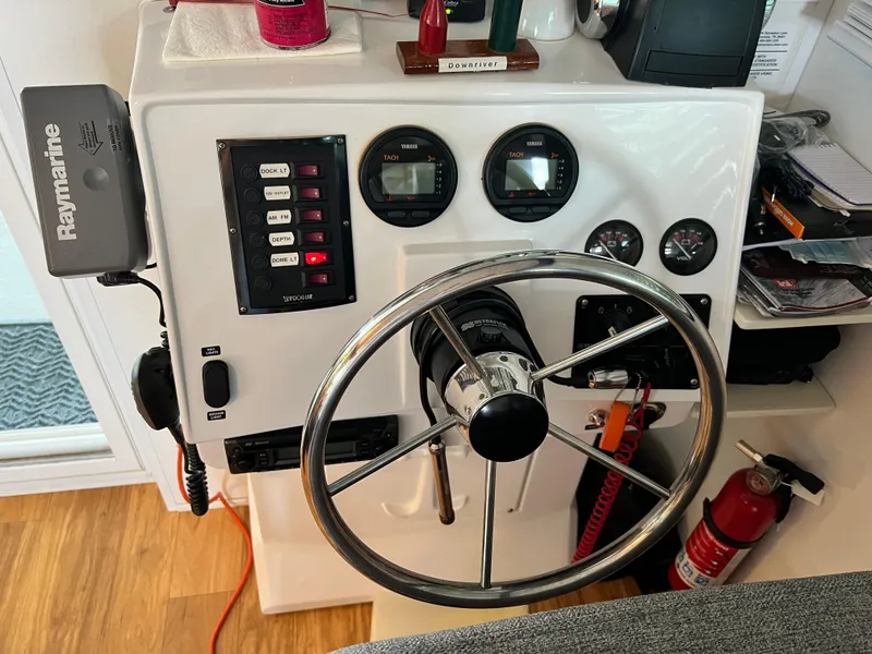 Slide: The Image of Steering console of 2021 Catamaran Cruisers 39 x 12 Houseboat with gauges and controls. - 12