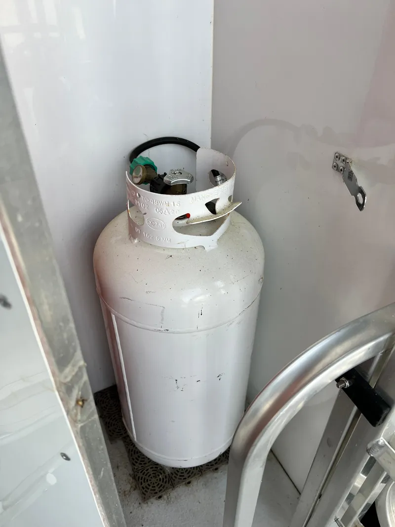 Slide: The Image of Propane tank inside a 2021 Catamaran Cruisers 39 x 12 houseboat compartment. - 18