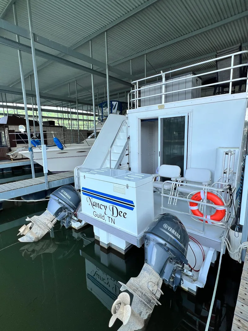 Slide: The Image of 2021 Catamaran Cruisers 39 x 12 Houseboat docked, featuring Yamaha engines and safety equipment. - 19