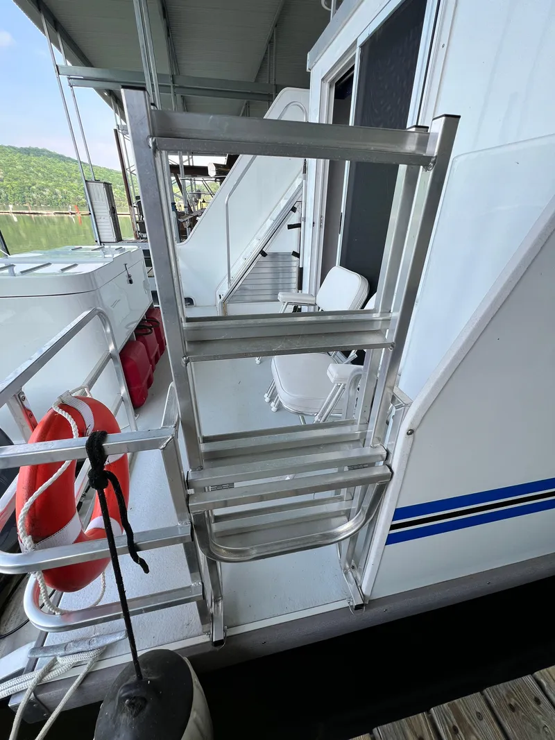 Slide: The Image of Aluminum ladder on 2021 Catamaran Cruisers 39 x 12 houseboat deck, with life preserver nearby. - 20