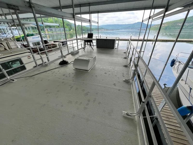 Slide: The Image of 2021 Catamaran Cruisers 39 x 12 Houseboat docked with scenic lake view. - 21