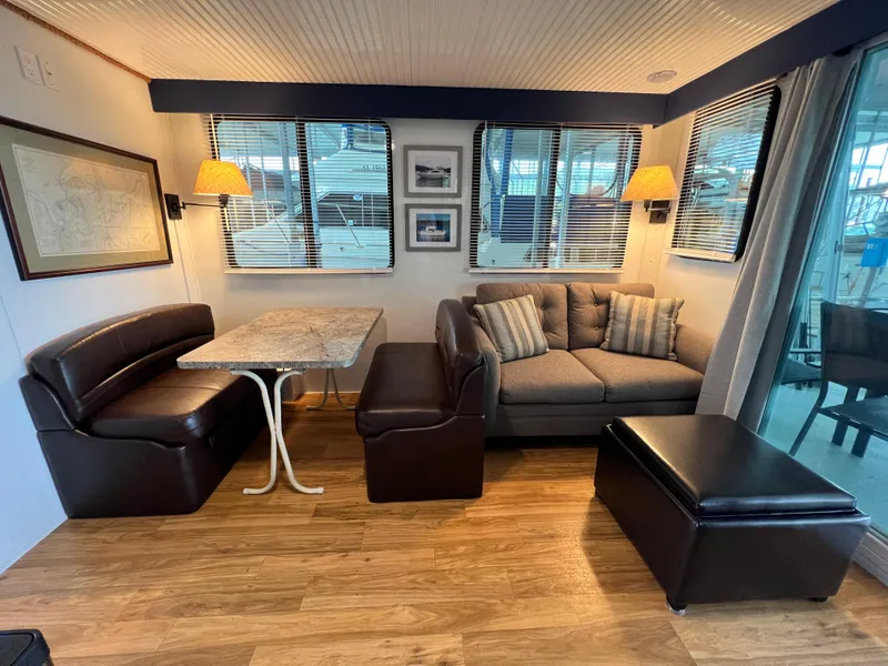 Slide: The Image of Interior of 2021 Catamaran Cruisers houseboat with cozy seating and dining area. - 3