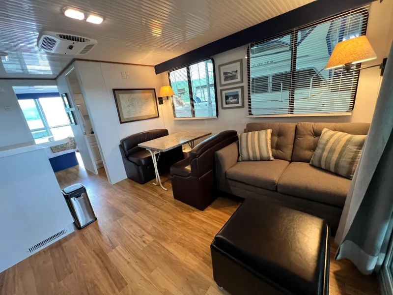 Slide: The Image of Interior of 2021 Catamaran Cruisers houseboat with cozy seating and dining area. - 4