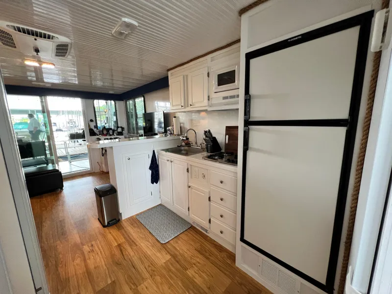 Slide: The Image of Interior of 2021 Catamaran Cruisers 39 x 12 houseboat kitchen with modern appliances. - 7