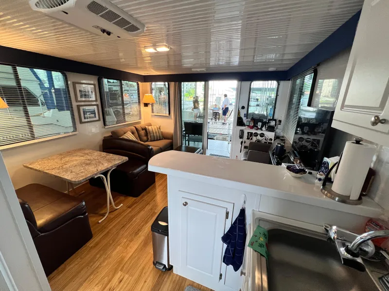 Slide: The Image of Interior of 2021 Catamaran Cruisers 39 x 12 Houseboat with modern kitchen and cozy seating area. - 8