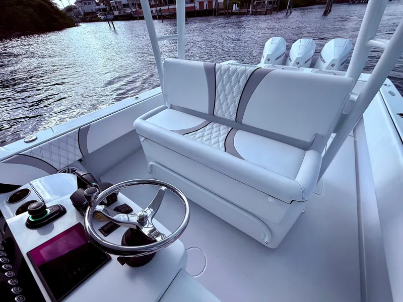 Slide: The Image of 2024 Contender 39 ST boat interior with sleek seating and modern controls. - 15